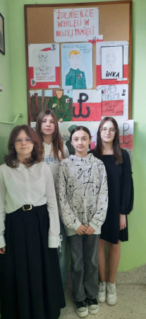 Grupa uczniów przy gazetce poświęconej Żołnierzom Wyklętym – moment refleksji, zdjęcie 3 z 5