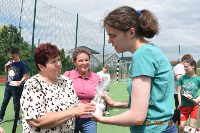 Seniorzy i uczniowie wspólnie rozmawiają podczas spotkania w szkole, zdjęcie 4 z 5