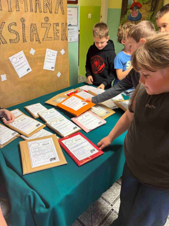 Dzieci oglądają dostępne lektury podczas wymiany książek w bibliotece, zdjęcie 2 z 5